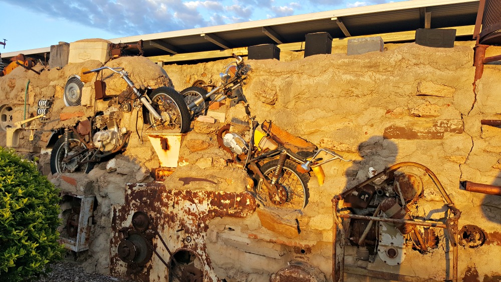 Sunrise hitting some motorbikes embedded in Arno's Wall.