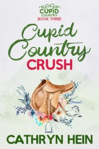 ebook cover of Cupid Country Crush by Cathryn Hein featuring a saddle surround by flowers on a pale green background